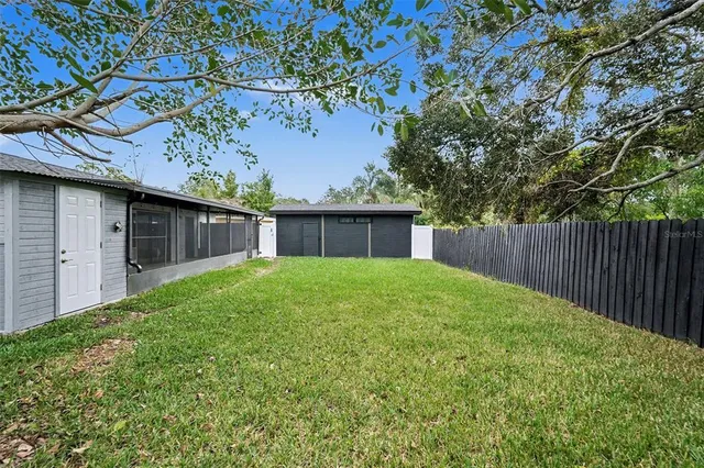 a view of an house with backyard space and balcony