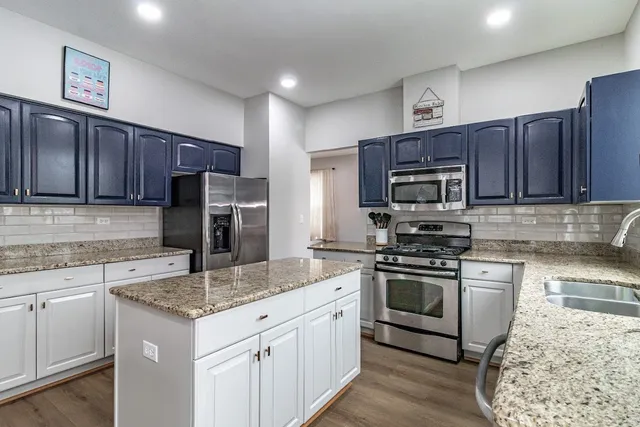 a kitchen with a sink stove and refrigerator