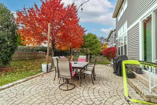 a view of a chairs and table in backyard of the house
