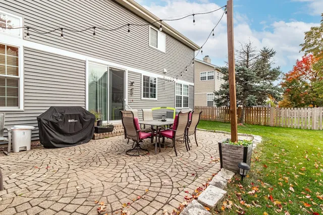 a view of a backyard with table and chairs and a patio