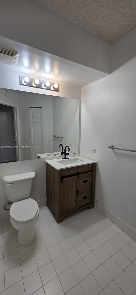 17150 North Bay Road, Unit 2602 Sunny Isles Beach, FL 33160 - Photo 15 of 27 a bathroom with a sink toilet and a mirror