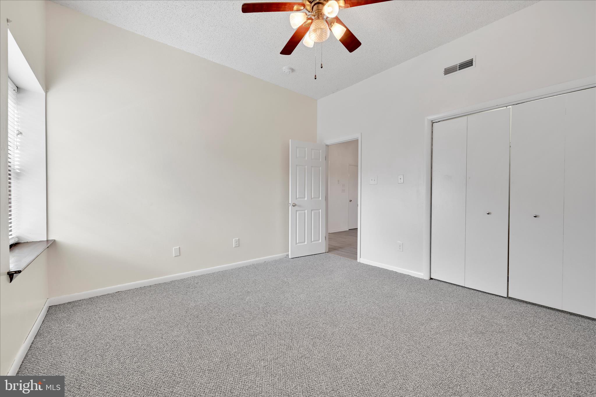 709 Hill Road, Unit 7 Wernersville, PA 19565 - Photo 17 of 24 an empty room with a ceiling fan and a window