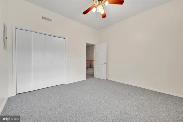 an empty room with a empty space and chandelier fan