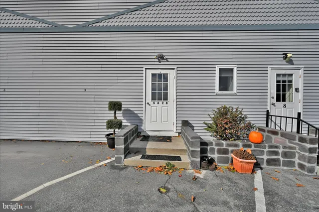 a view of a patio with a table and chairs and potted plants