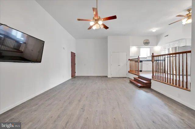 a view of room with stairs and a flat screen tv