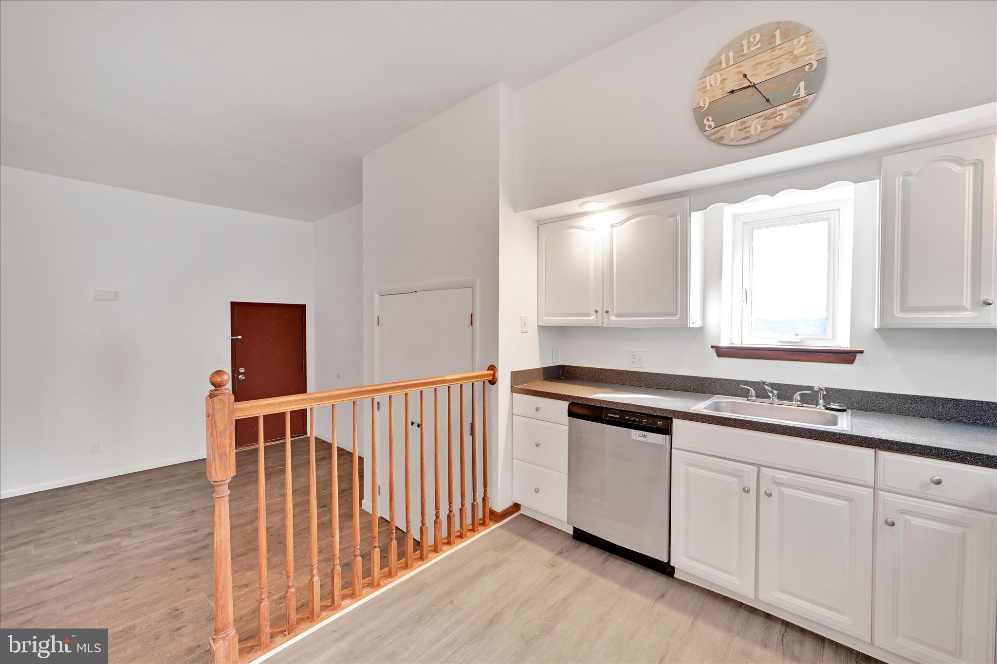 709 Hill Road, Unit 7 Wernersville, PA 19565 - Photo 9 of 24 a kitchen with granite countertop white cabinets and window