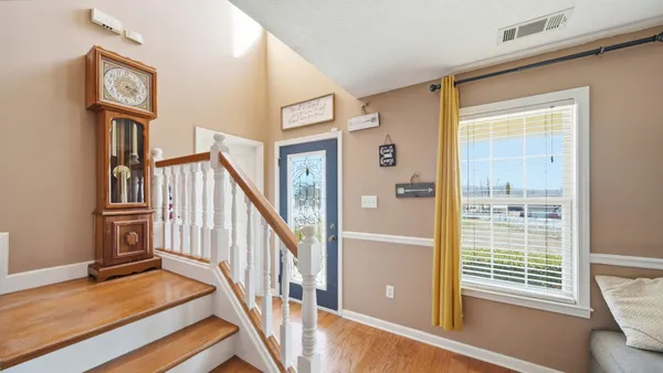 a view of entryway livingroom and hall with wooden floor