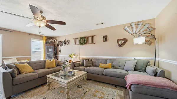 a living room with furniture and a fireplace