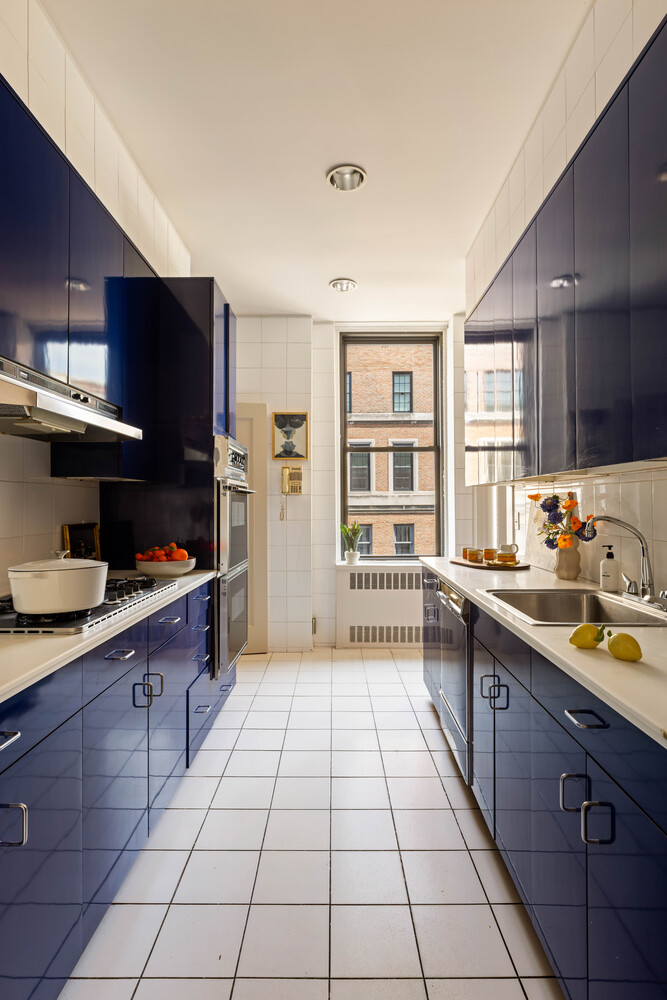 993 Park Avenue, Unit 11A Manhattan, NY 10028 - Photo 11 of 24 a view of a kitchen with a sink and cabinets