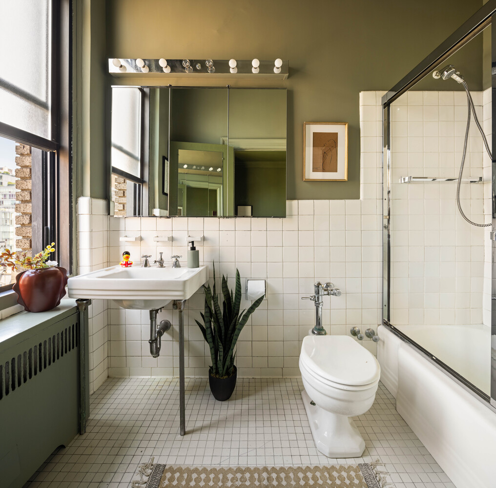 993 Park Avenue, Unit 11A Manhattan, NY 10028 - Photo 17 of 24 a bathroom with a sink toilet a mirror and shower