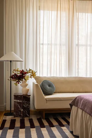 a bedroom with a bed and teddy bear on bed