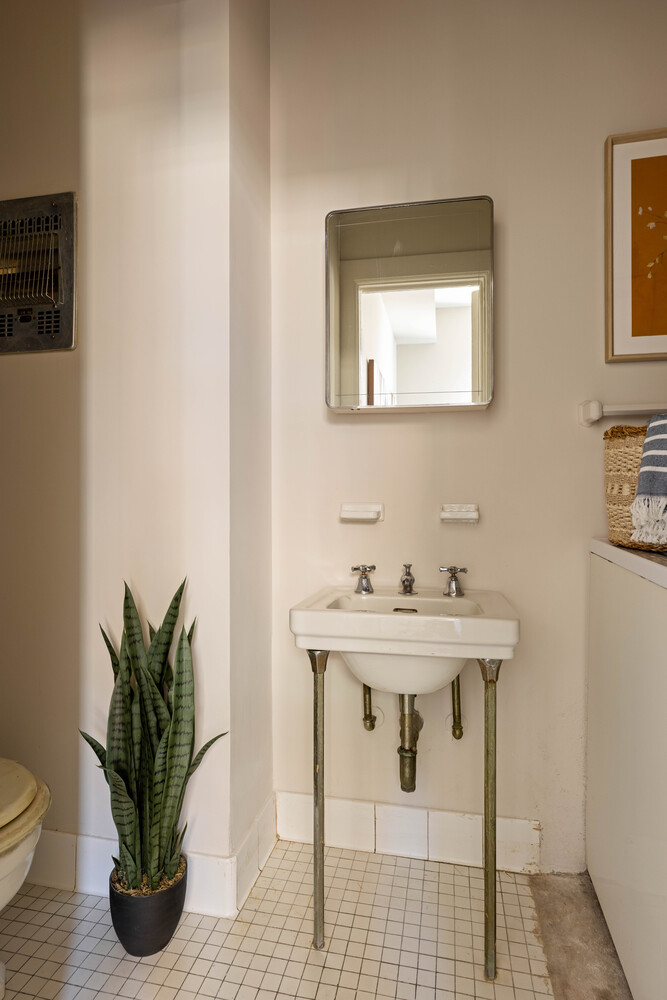 993 Park Avenue, Unit 11A Manhattan, NY 10028 - Photo 23 of 24 a white bath tub sitting next to a white sink