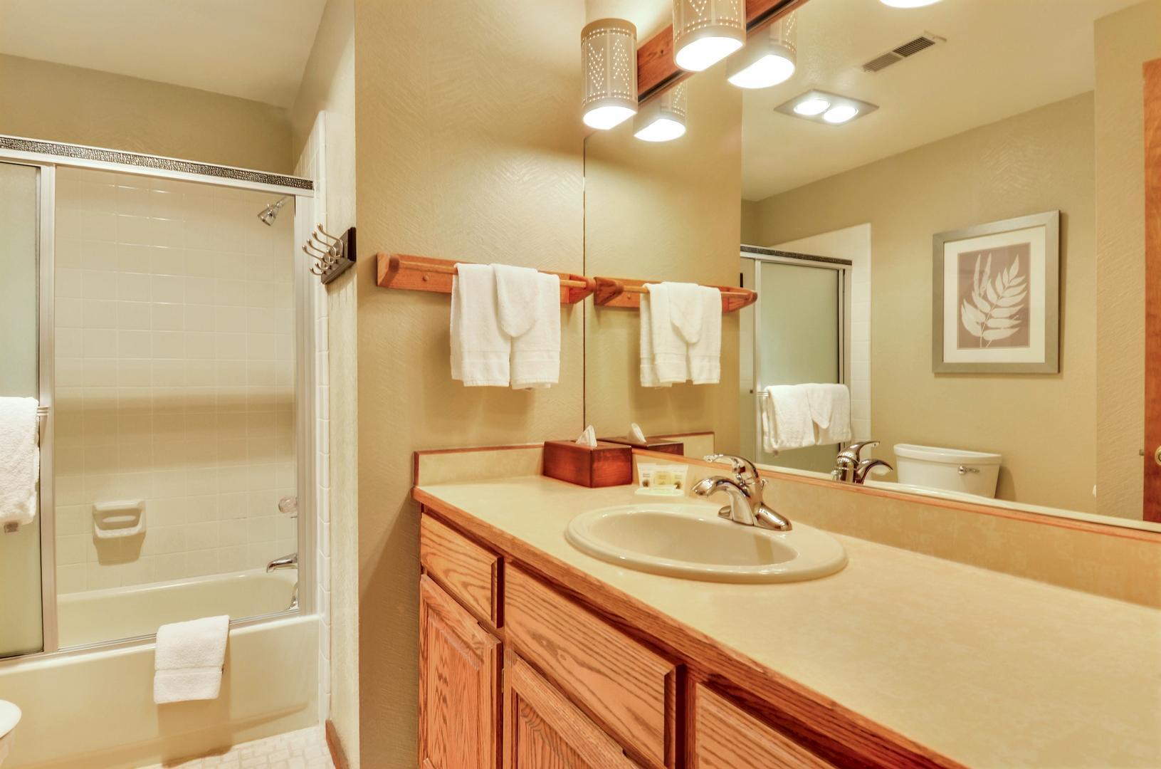 57301 Beaver Ridge Loop, Unit 10 Sunriver, OR 97707 - Photo 15 of 23 a bathroom with a granite countertop sink a toilet and shower