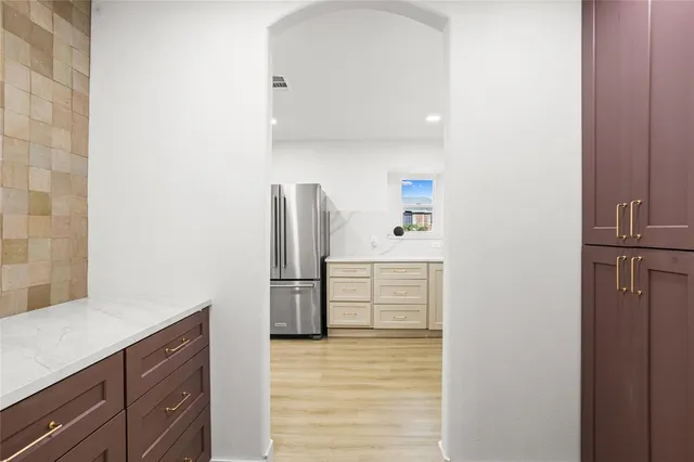 a kitchen with a refrigerator and cabinets
