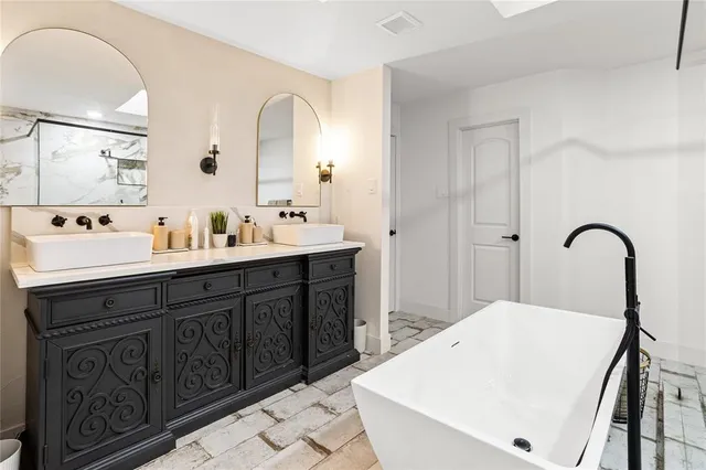 a spacious bathroom with a sink and a mirror