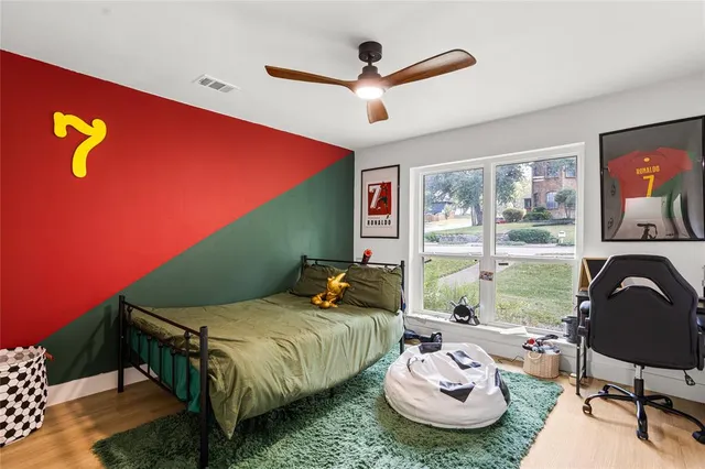 a bedroom with a bed and a large window