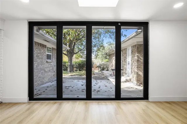 a view of a glass door with a big yard