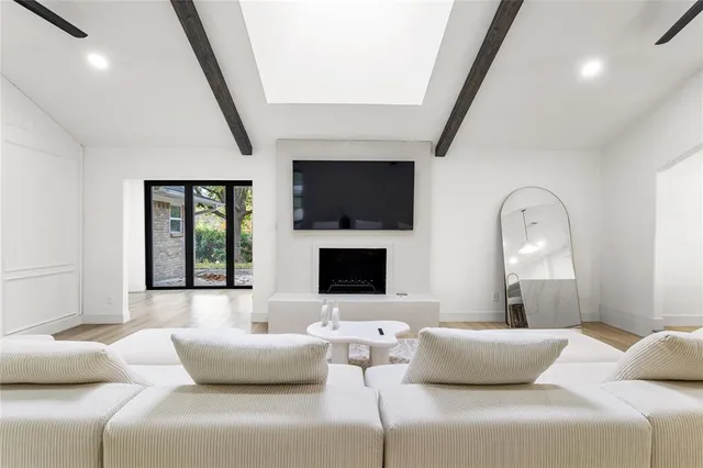 a living room with furniture flat screen tv and a fireplace