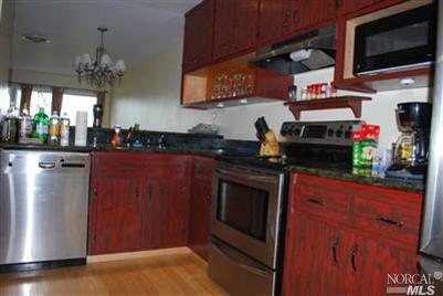 8 Ross Road Sausalito, CA 94965 - Photo 1 of 1 a kitchen with stainless steel appliances granite countertop a refrigerator and a stove top oven
