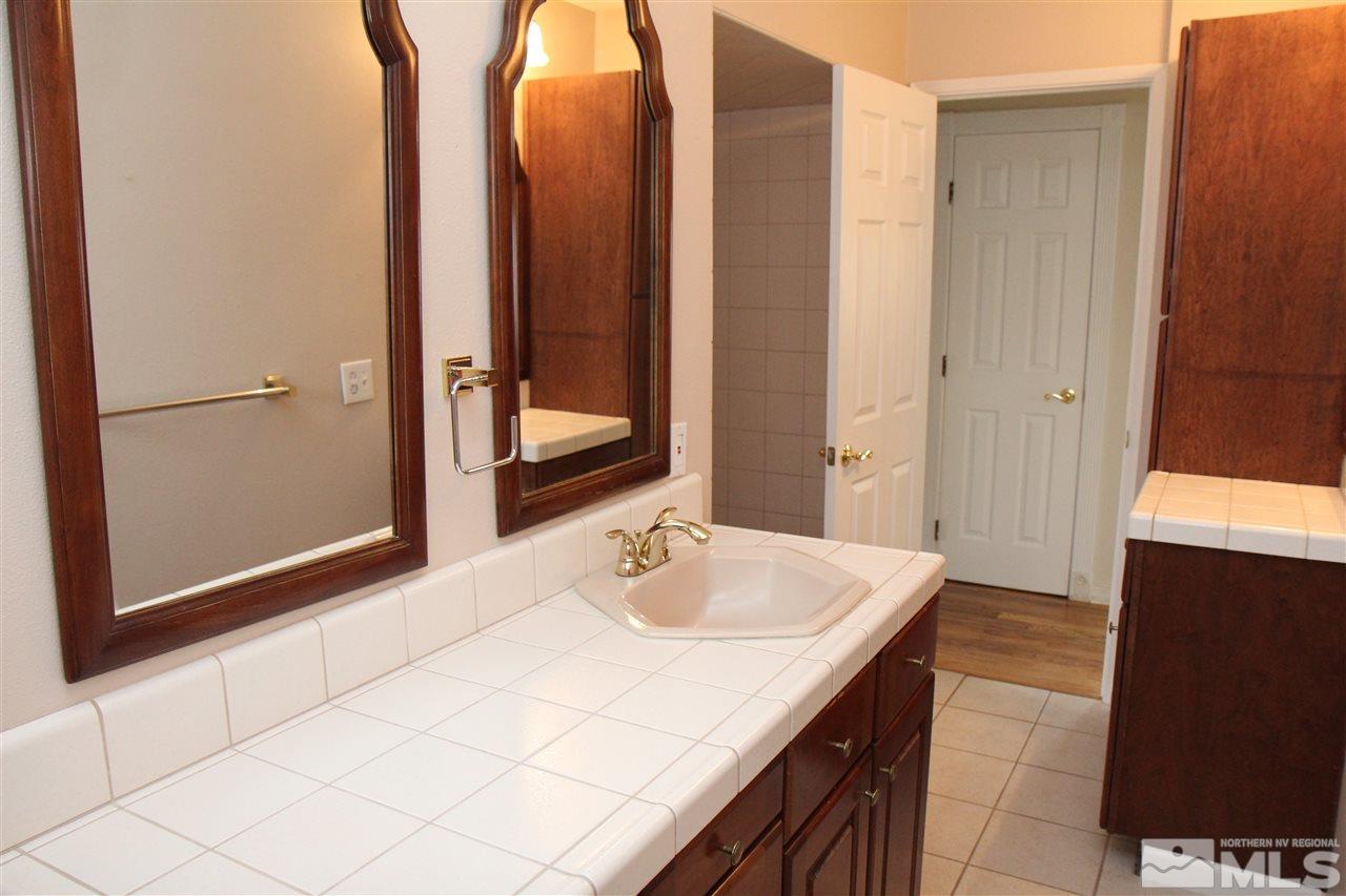 14170 Rim Rock Drive Reno, NV 89521 - Photo 13 of 25 a bathroom with a sink and a mirror