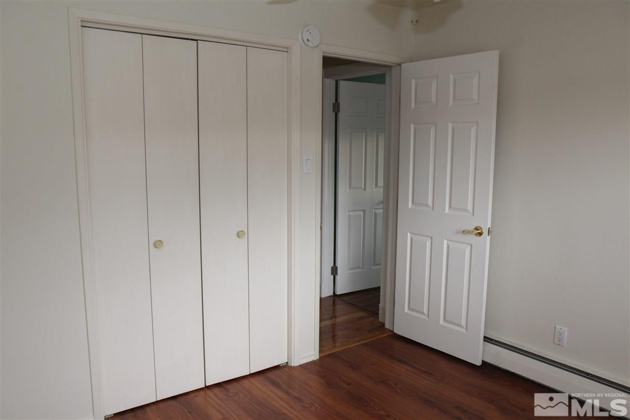 14170 Rim Rock Drive Reno, NV 89521 - Photo 14 of 25 a view of an empty room with wooden floor