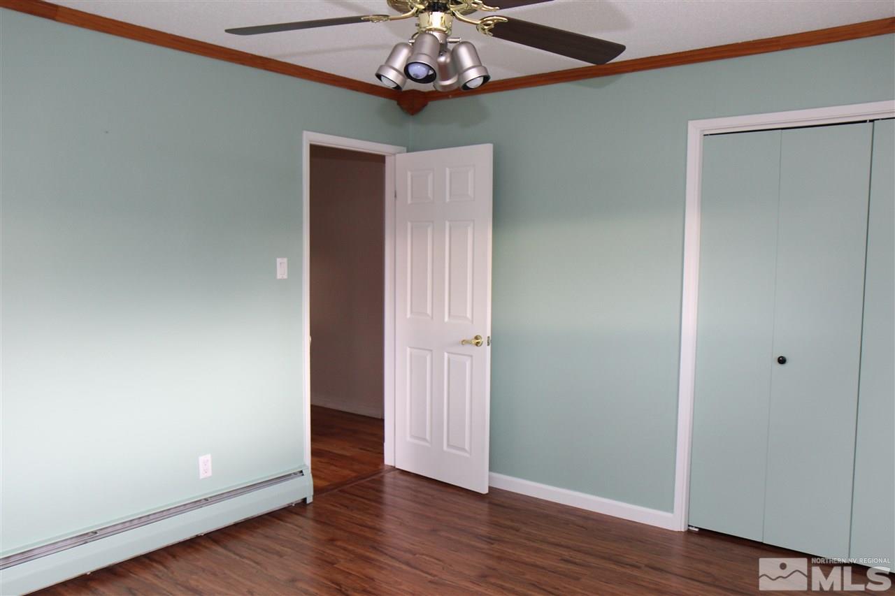 14170 Rim Rock Drive Reno, NV 89521 - Photo 15 of 25 a view of an empty room with wooden floor