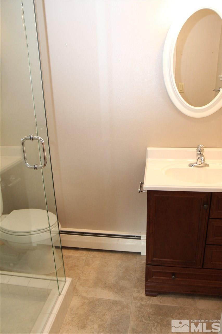 14170 Rim Rock Drive Reno, NV 89521 - Photo 17 of 25 a bathroom with a sink a toilet and a mirror