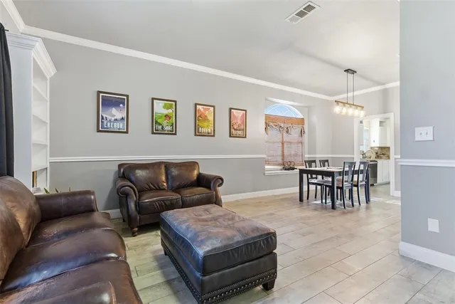 a living room with furniture and a dining table with kitchen view