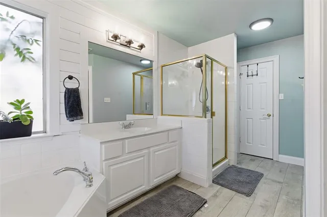 a bathroom with a shower sink and mirror