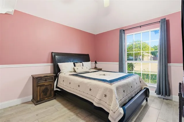 a bed sitting in a bedroom next to a window