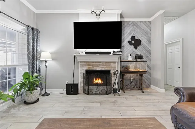 a living room with furniture a flat screen tv and a fireplace