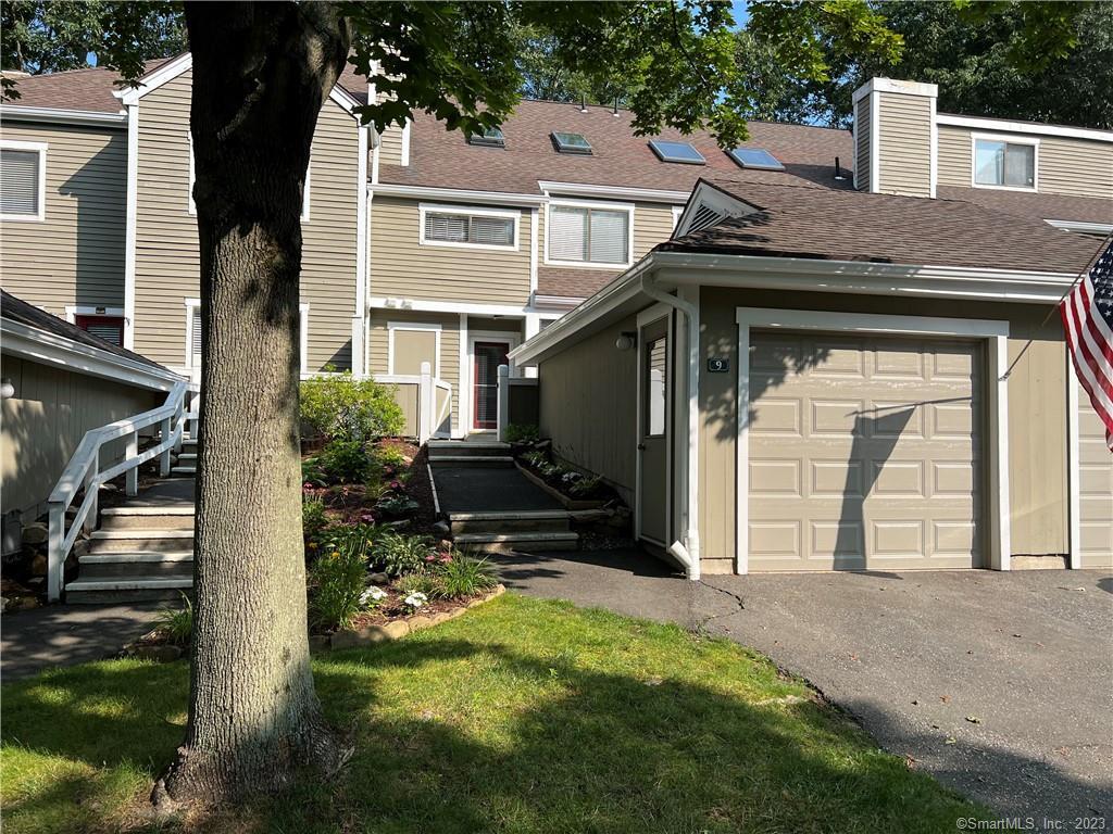 a view of a house with backyard and porch