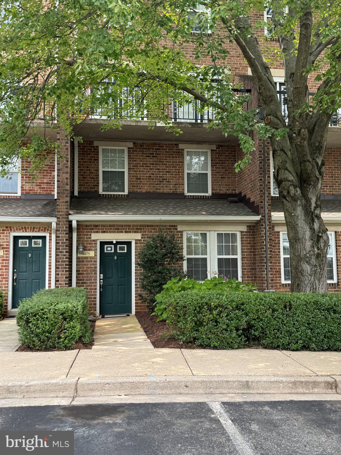 4075 Chesterwood Drive, Unit 4075 Silver Spring, MD 20906 - Photo 1 of 8 Charming brick facade with lush greenery.