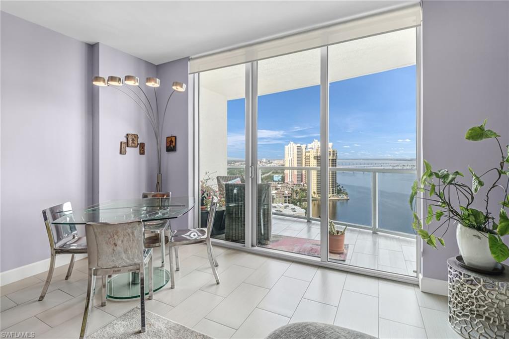 3000 Oasis Grand Boulevard, Unit 2205 Fort Myers, FL 33916 - Photo 12 of 42 a dining room with furniture and a potted plant