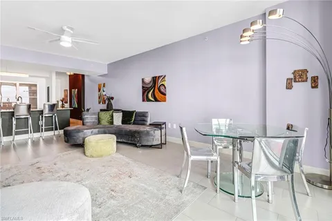 a living room with furniture and kitchen view