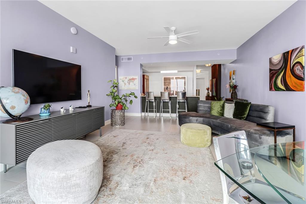 3000 Oasis Grand Boulevard, Unit 2205 Fort Myers, FL 33916 - Photo 15 of 42 a living room with furniture and a flat screen tv