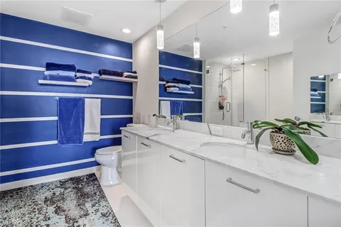 a bathroom with a double vanity sink and a toilet