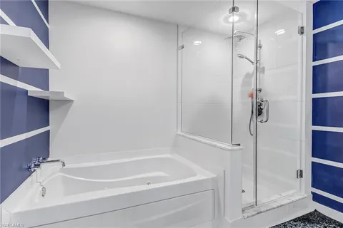a bathroom with a bathtub and a shower