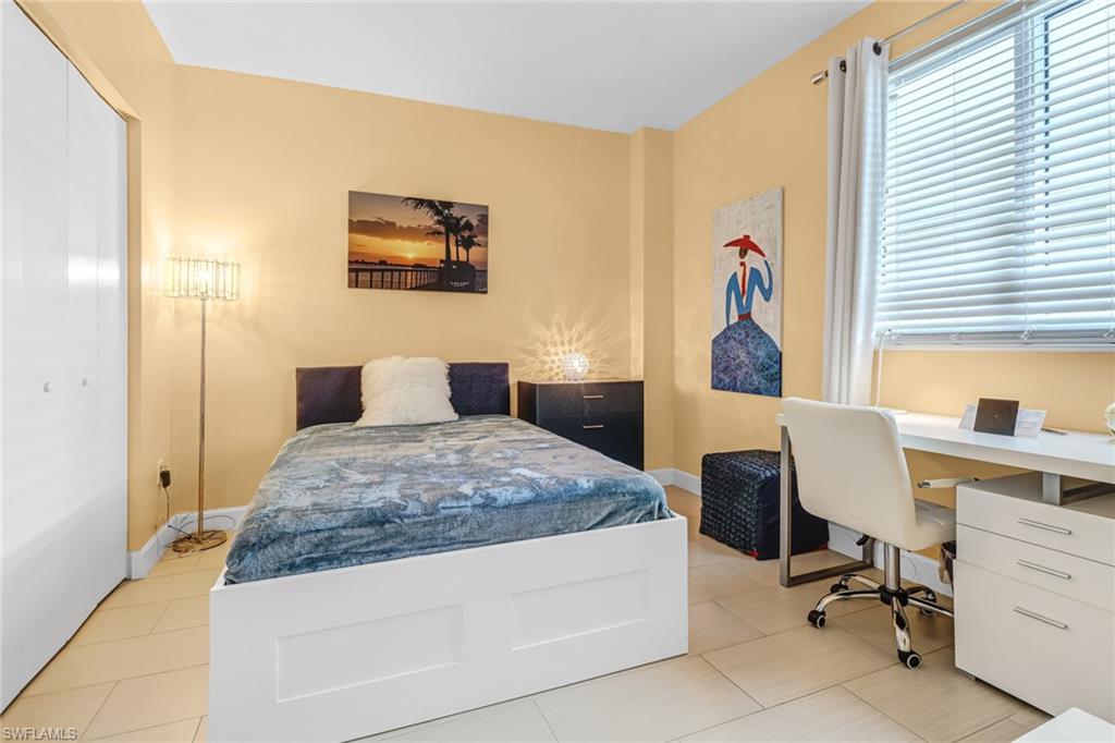 3000 Oasis Grand Boulevard, Unit 2205 Fort Myers, FL 33916 - Photo 22 of 42 a bedroom with a bed and a desk