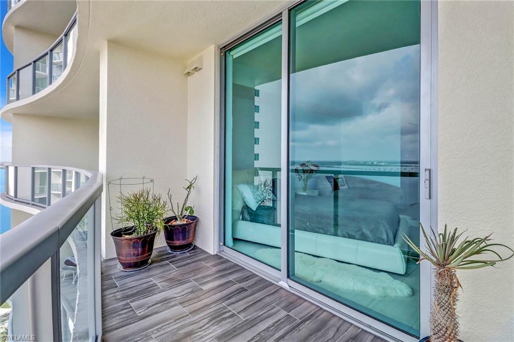 3000 Oasis Grand Boulevard, Unit 2205 Fort Myers, FL 33916 - Photo 25 of 42 a view of a hallway with a potted plant