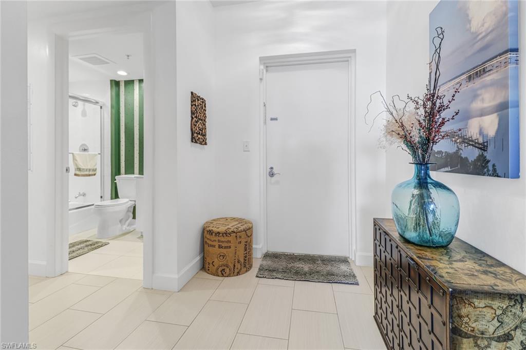 3000 Oasis Grand Boulevard, Unit 2205 Fort Myers, FL 33916 - Photo 26 of 42 a view of an entryway with wooden floor