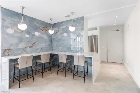 a kitchen with a table and chairs in it