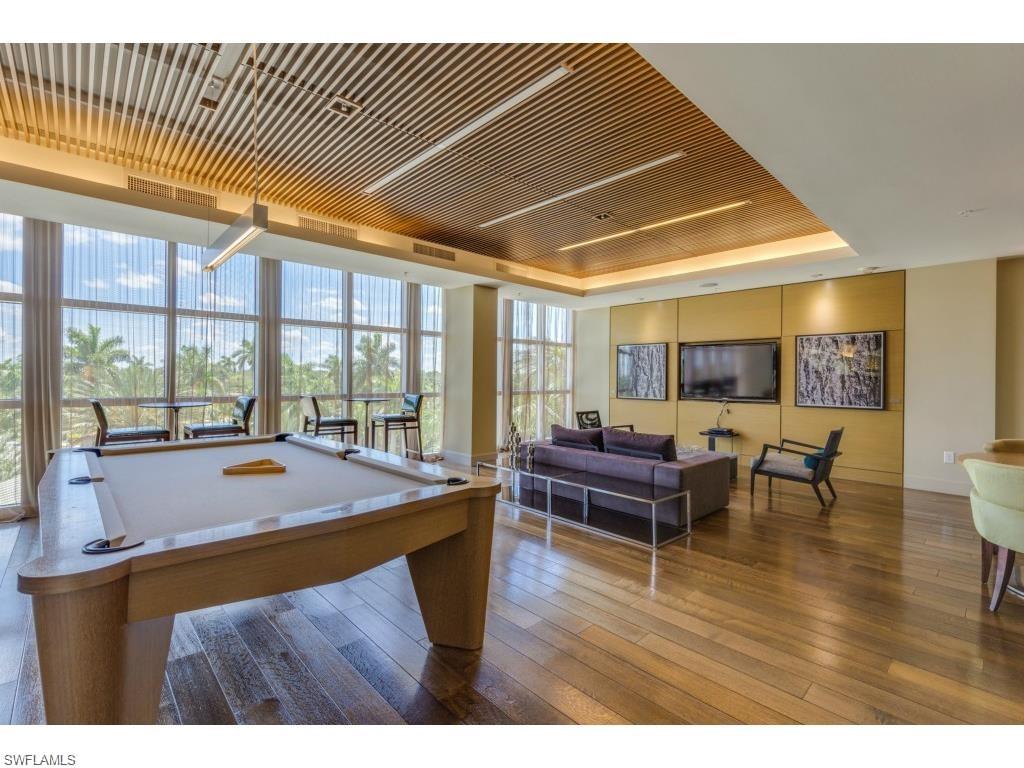 3000 Oasis Grand Boulevard, Unit 2205 Fort Myers, FL 33916 - Photo 35 of 42 a room with furniture and wooden floor