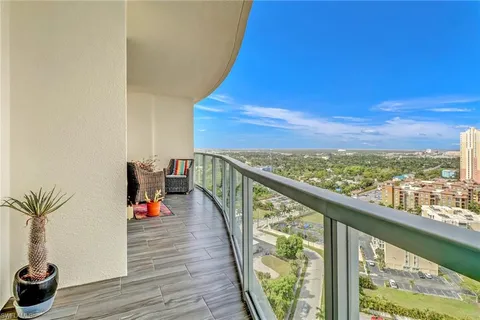 a view of a balcony with chair and wooden floor