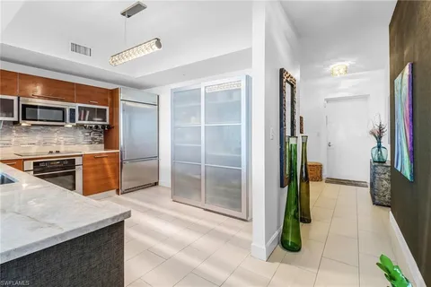 a kitchen with granite countertop a refrigerator and a stove
