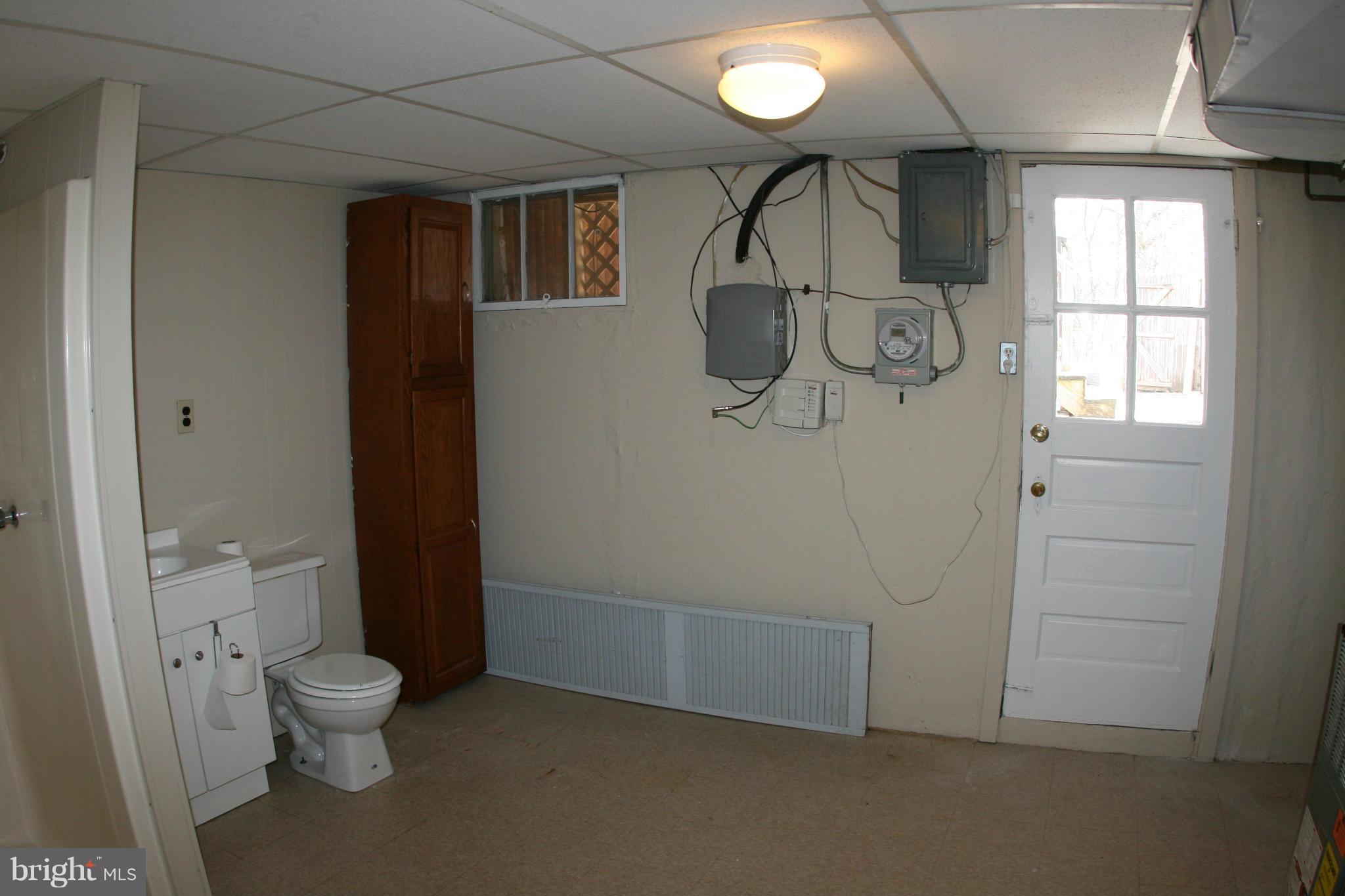 503 Welbrook Road Baltimore, MD 21221 - Photo 20 of 24 a bathroom with a granite countertop sink a toilet and a shower