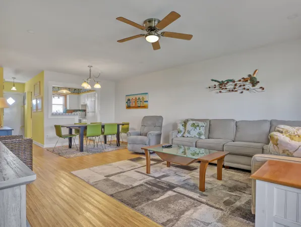 a living room with furniture and kitchen view