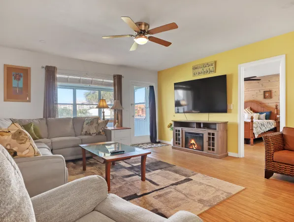 a living room with furniture a fireplace and a flat screen tv
