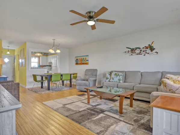 a living room with furniture and kitchen view