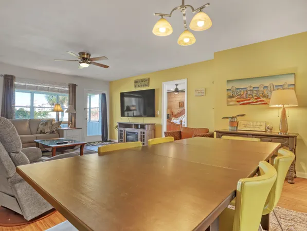 a living room with dining table and chairs